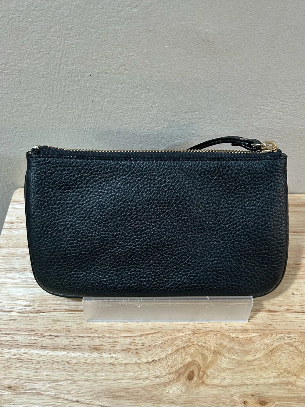 kate spade black pebbled leather wristlet with gold-tone logo